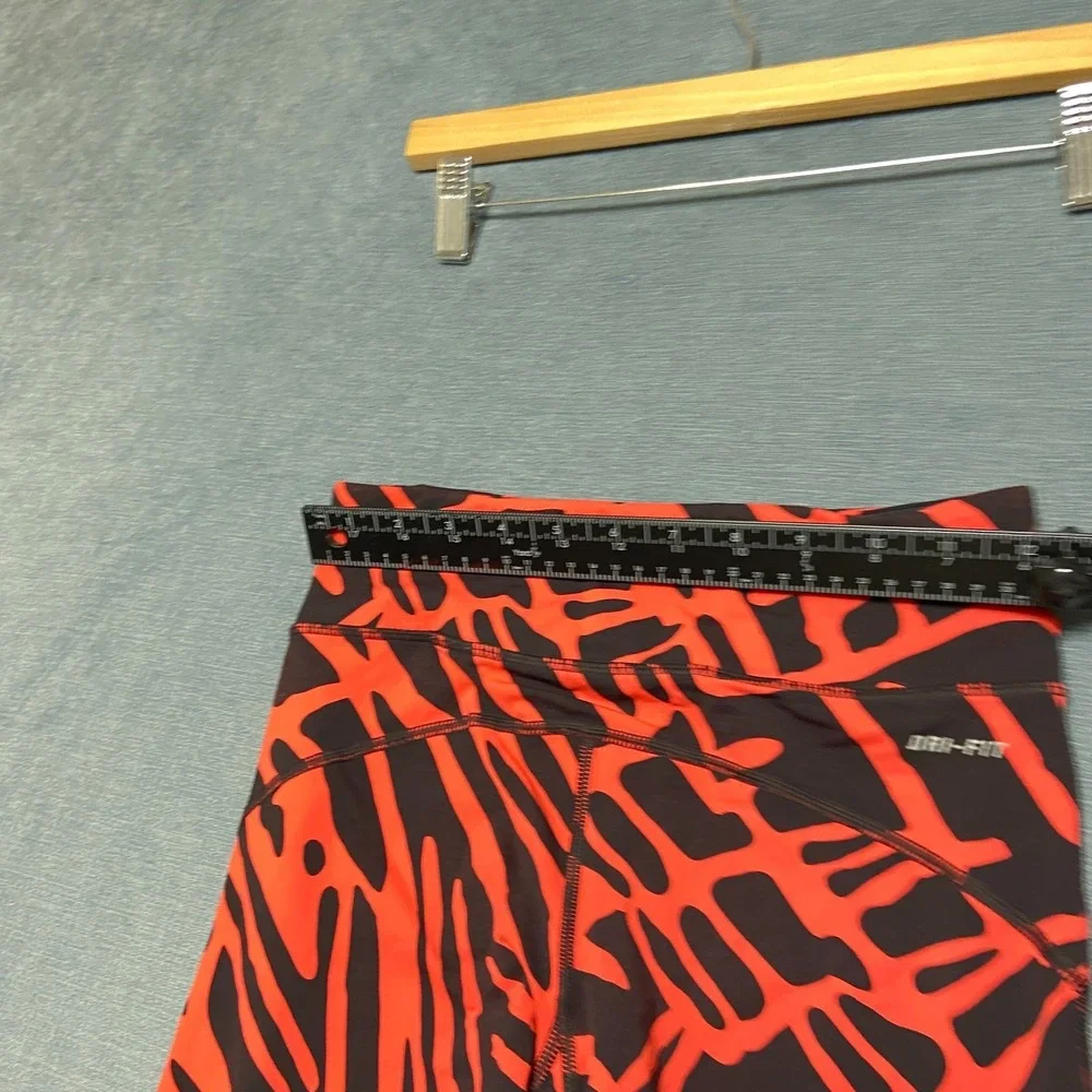 Nike Dri Fit Power Epic Lux Capri Leggings Womens XS Black Orange Abstract Print